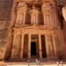 The Treasury in Petra, Jordan, carved into reddish sandstone cliffs, a symbol of Nabatean architecture and geological marvel—featured in the Petra science travel guide.