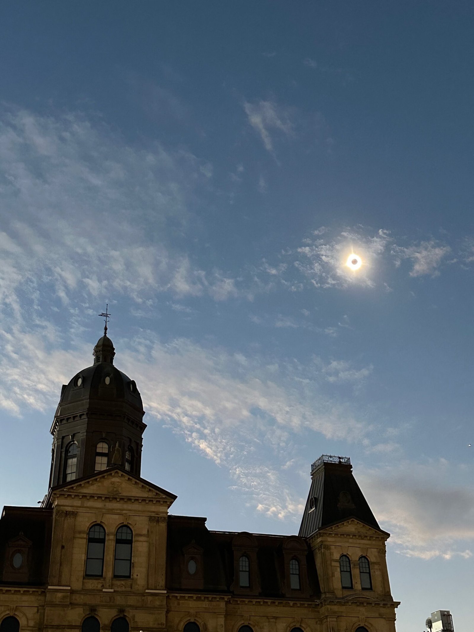 Total solar eclipse with the sun's corona visible over the Legislative Assembly of New Brunswick in Fredericton, New Brunswick, during the April 8, 2024, eclipse.