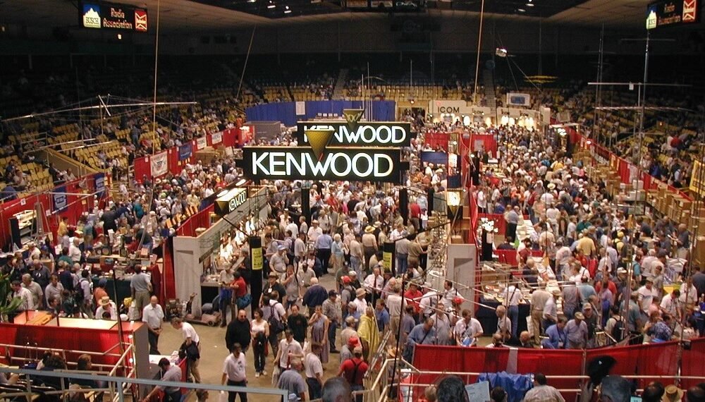 Participants crowded on the show floor at Dayton Hamvention, exploring vendors selling equipment and showcasing top ham radio destinations.