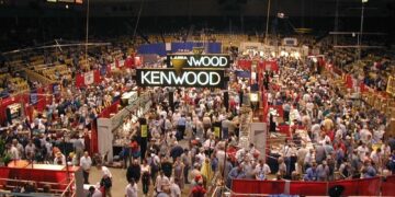 Participants crowded on the show floor at Dayton Hamvention, exploring vendors selling equipment and showcasing top ham radio destinations.