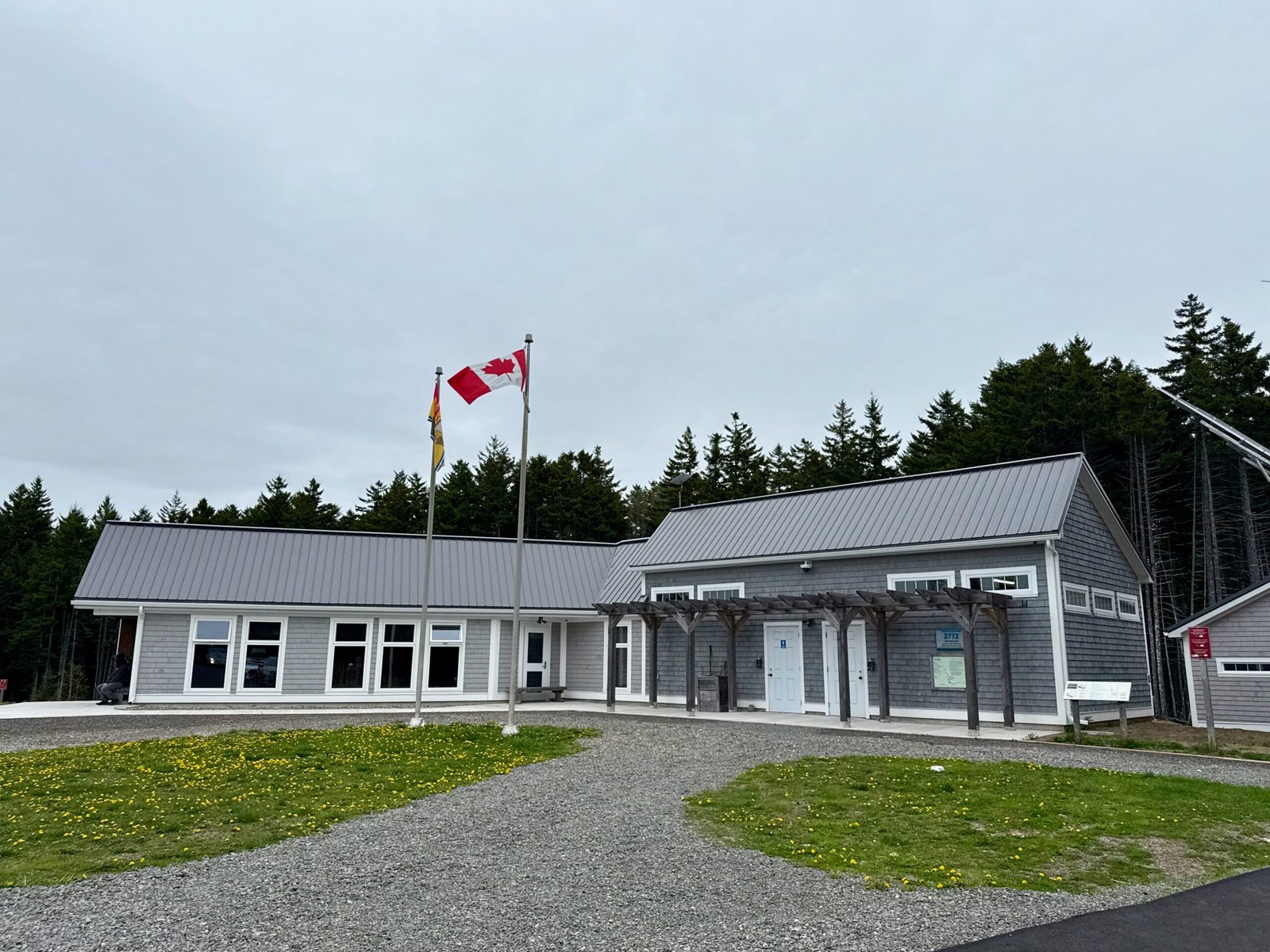 Fundy Trail Parkway East Gate Visitor Information Centre with signage and surrounding forest
