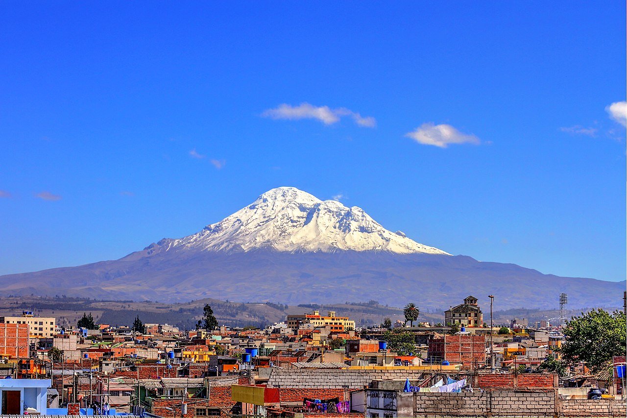Snow-capped Chimborazo Volcano rising behind Riobamba, Ecuador—one of the highest places where time slows down due to altitude and gravity.
