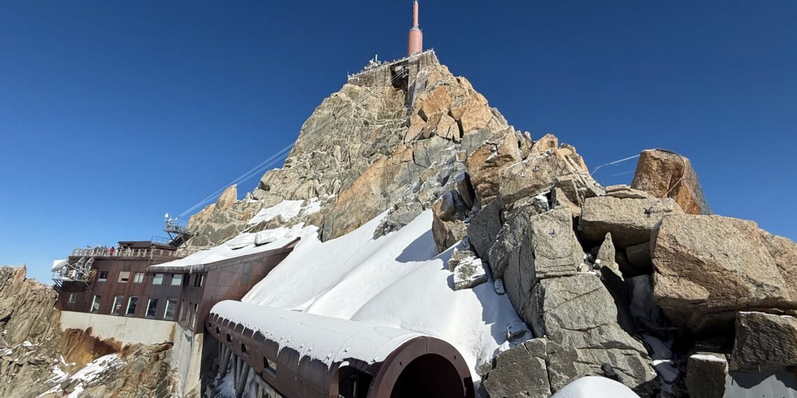 Aiguille du Midi summit station seen from the Mont Blanc side, with a snow-covered tubular passage leading toward the observation decks.