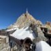 Aiguille du Midi summit station seen from the Mont Blanc side, with a snow-covered tubular passage leading toward the observation decks.