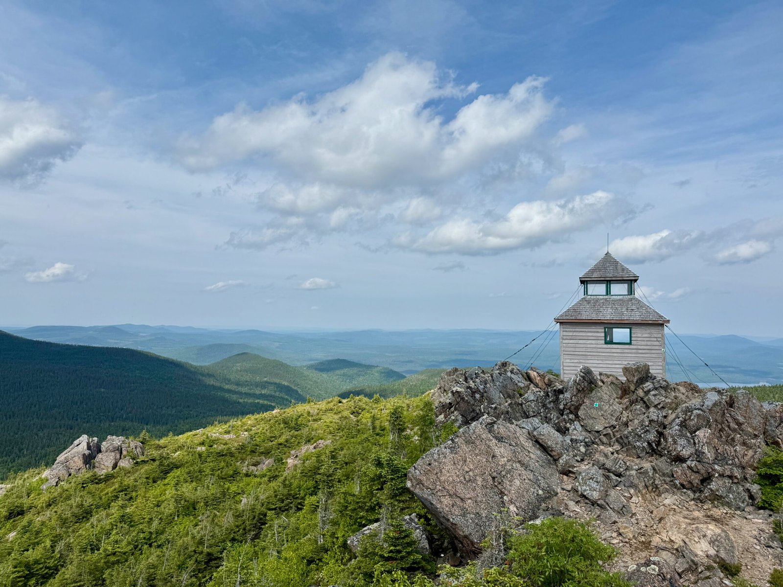 Wooden fire lookout tower at the summit of Mount Carleton with sweeping views of the Appalachian Mountains and Acadian forest in New Brunswick.