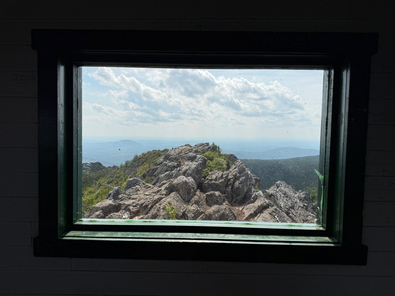 Appalachian Mountains seen through the fire lookout window at the summit of Mount Carleton, New Brunswick’s highest peak.