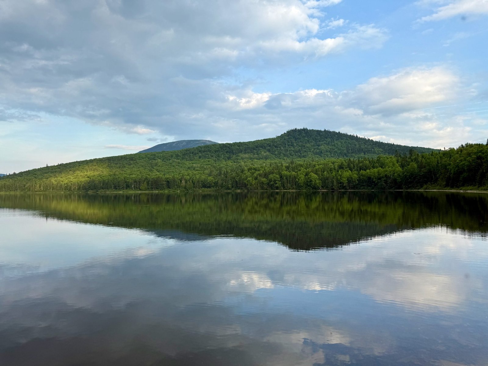 Mount Carleton reflecting on the calm surface of Nictau Lake in Mount Carleton Provincial Park, New Brunswick.