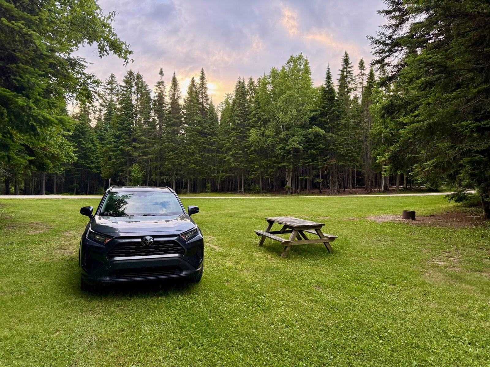 Campsite with picnic table and car at Armstrong Campground in Mount Carleton Provincial Park, New Brunswick.
