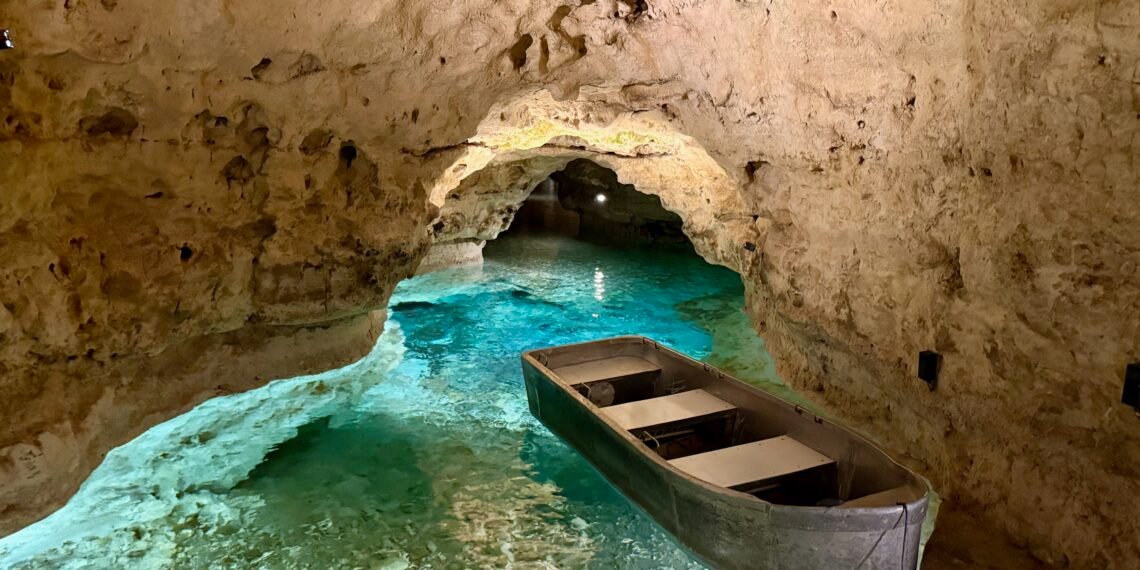 Boat on the blue underground river inside the Tapolca Lake Cave, Hungary.
