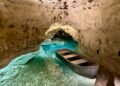 Boat on the blue underground river inside the Tapolca Lake Cave, Hungary.
