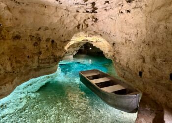 Boat on the blue underground river inside the Tapolca Lake Cave, Hungary.