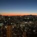 Tokyo Tower sunset view of the city skyline with Mount Fuji silhouetted on the horizon, seen from the main observation deck.