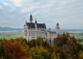 Neuschwanstein Castle seen from Marienbrücke in autumn, overlooking the Bavarian Alps, built from Jurassic limestone formed from an ancient coral reef.
