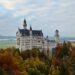 Neuschwanstein Castle seen from Marienbrücke in autumn, overlooking the Bavarian Alps, built from Jurassic limestone formed from an ancient coral reef.